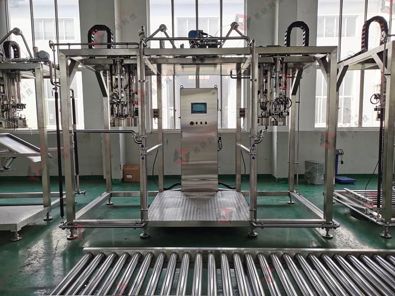 Double-head aseptic bag filling machine skid, front view, with roller conveyor interface for bag-in-drum packaging
