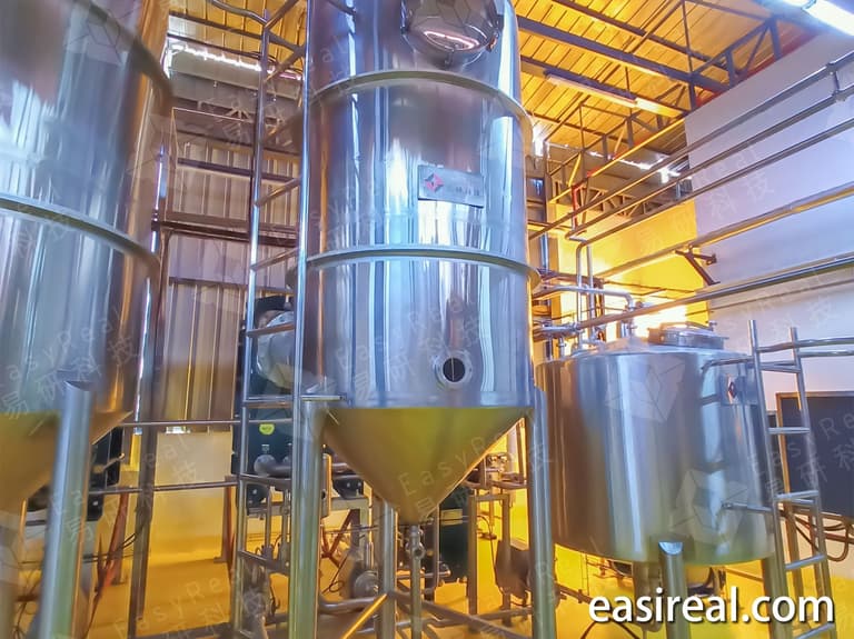 Wide view of the 3-effect plate evaporation line used to produce coconut water concentrate and prepare it for aseptic bag filling