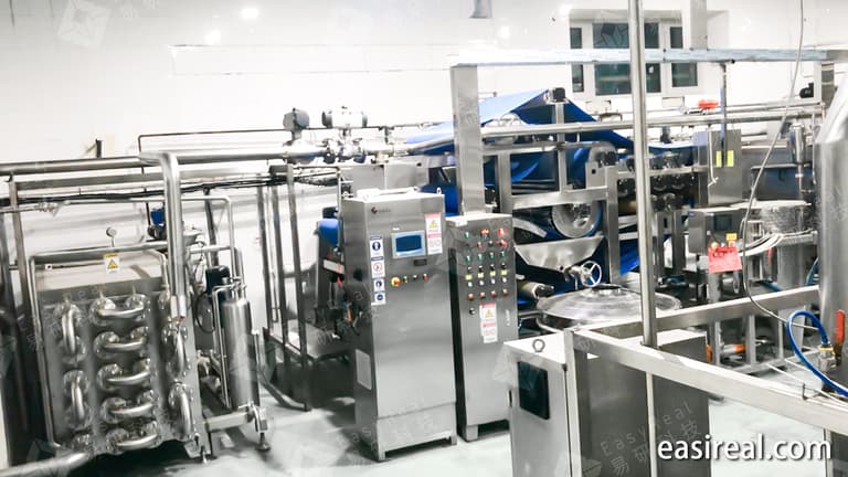 Carrot juice extraction and process control section with belt press and stainless steel piping for industrial carrot juice production