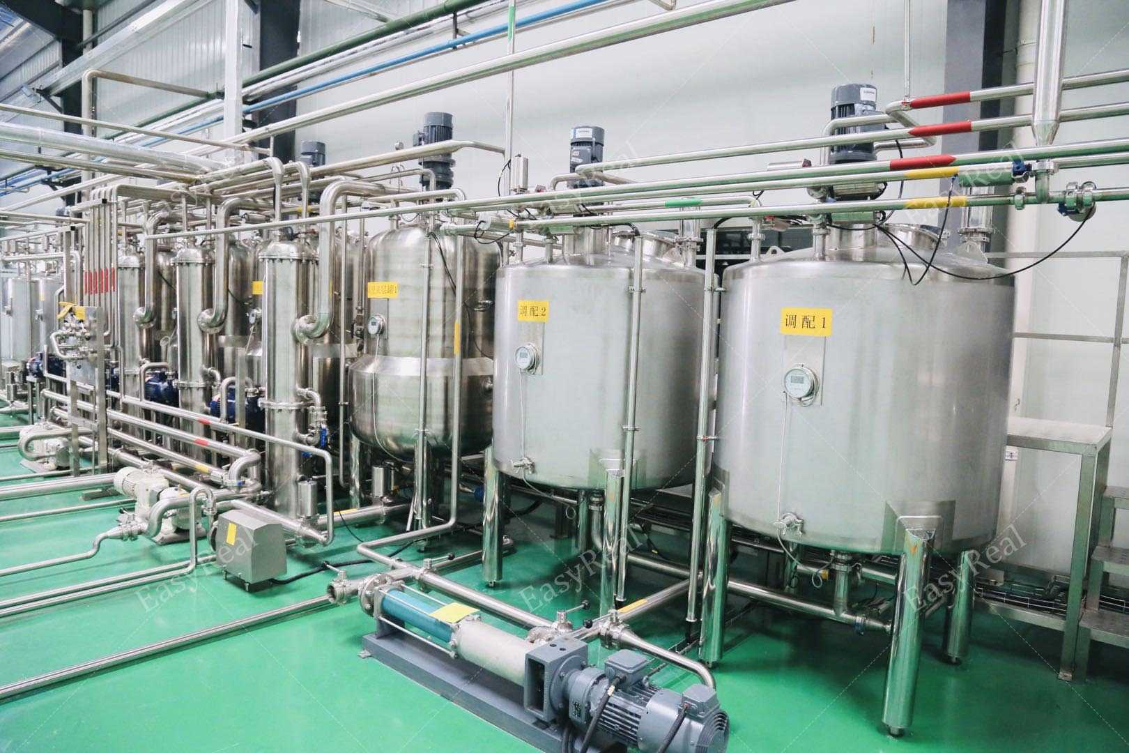 Row of EasyReal stainless steel enzymatic hydrolysis and mixing tanks connected by piping for liquid food and jam production.
