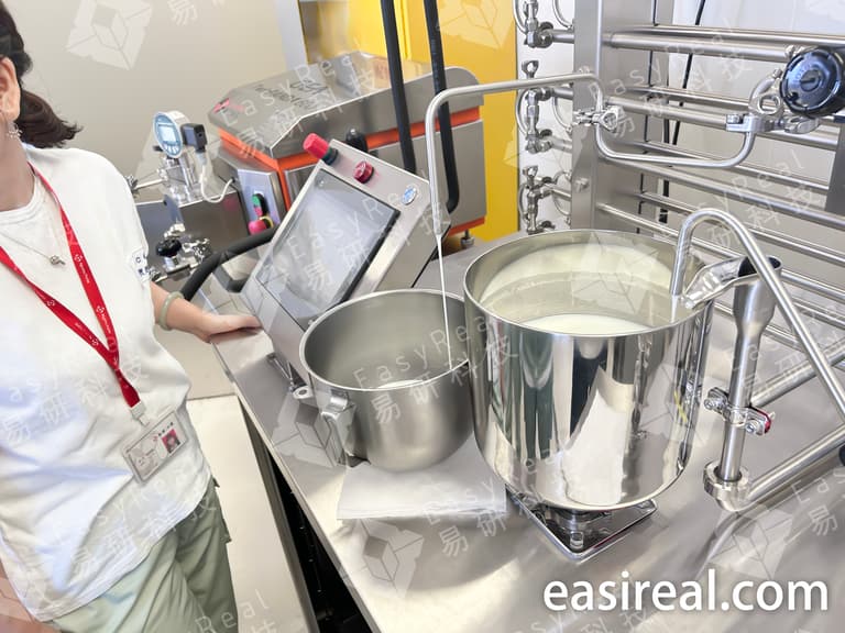 Close-up of whipping cream trial on EasyReal pilot UHT/HTST plant for Naw Chow Tianjin R&D, showing product tank, control interface, and pilot tubular sterilizer for dairy R&D testing