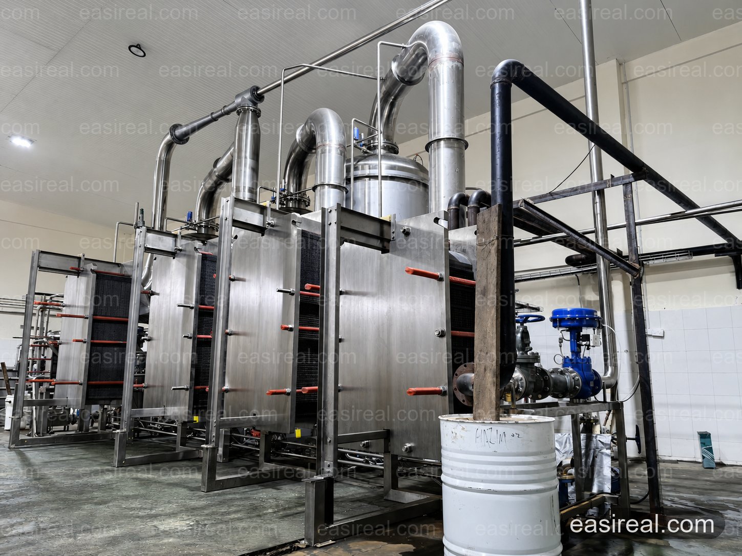 Triple-Effect Plate Evaporator Heat Exchangers and Vapor Piping Plate heat exchangers, vapor piping and control valves on the triple-effect coconut water evaporator