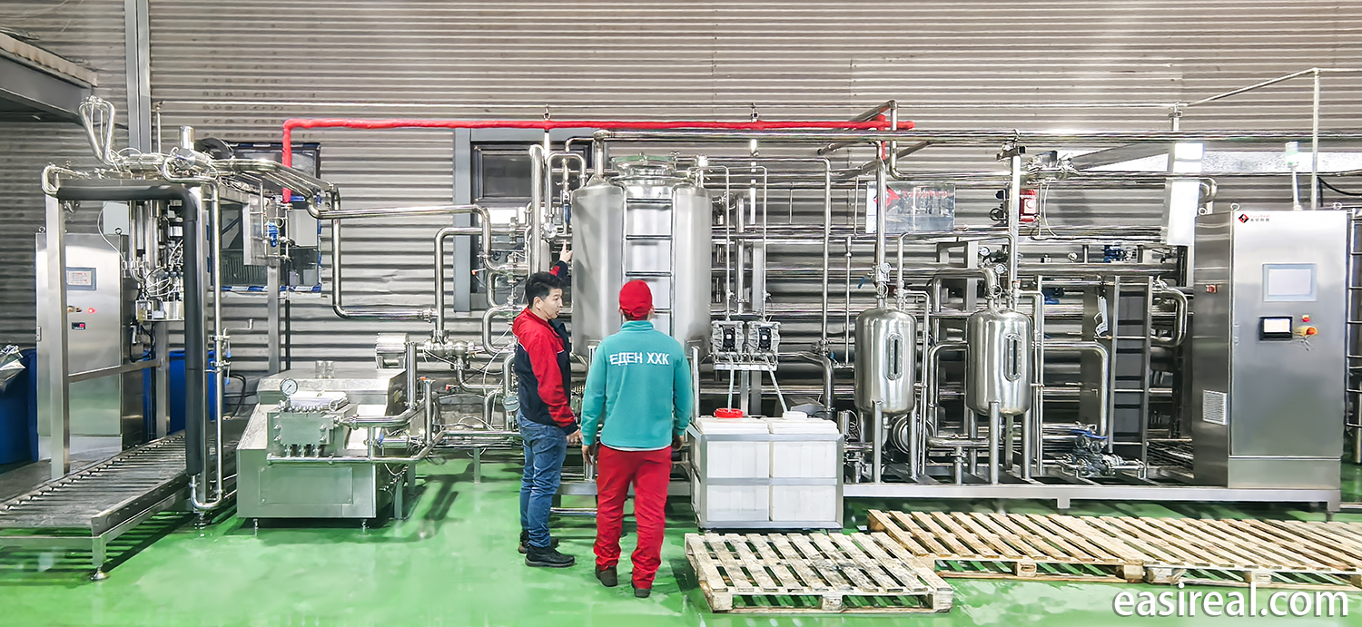 Shanghai EasyReal engineer explaining UHT sterilizer maintenance to Eden LLC technical staff at the Mongolia factory site.